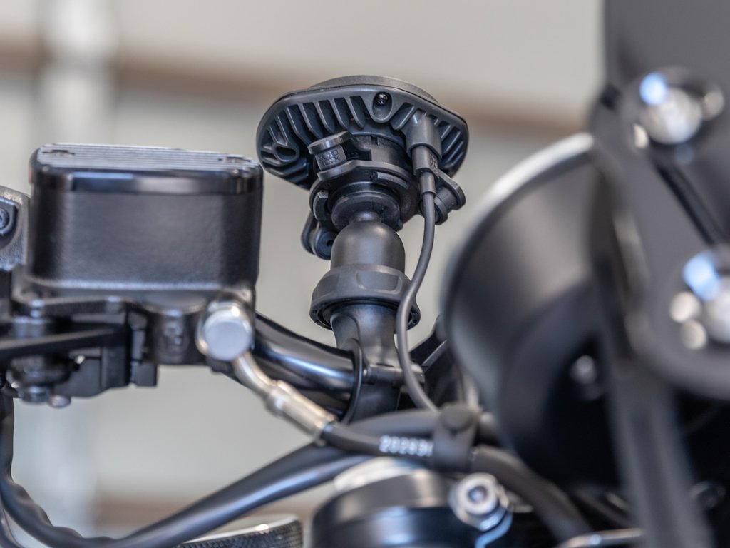 wireless charging attached to smartphone mount on motorbike