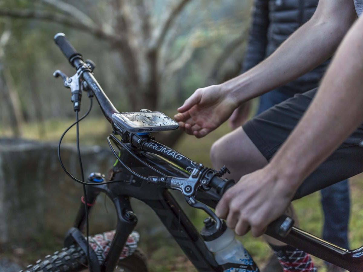 poncho on smartphone mounted to mountain bike