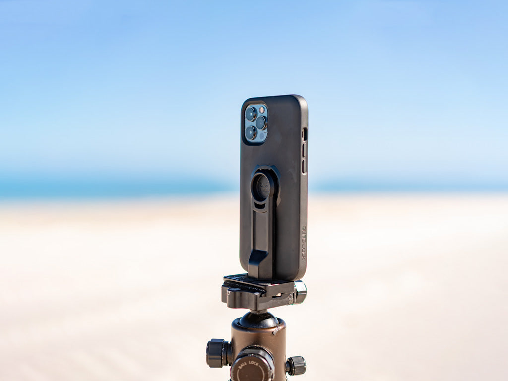 Quad Lock tripod adaptor with iPhone mounted and attached to tripod